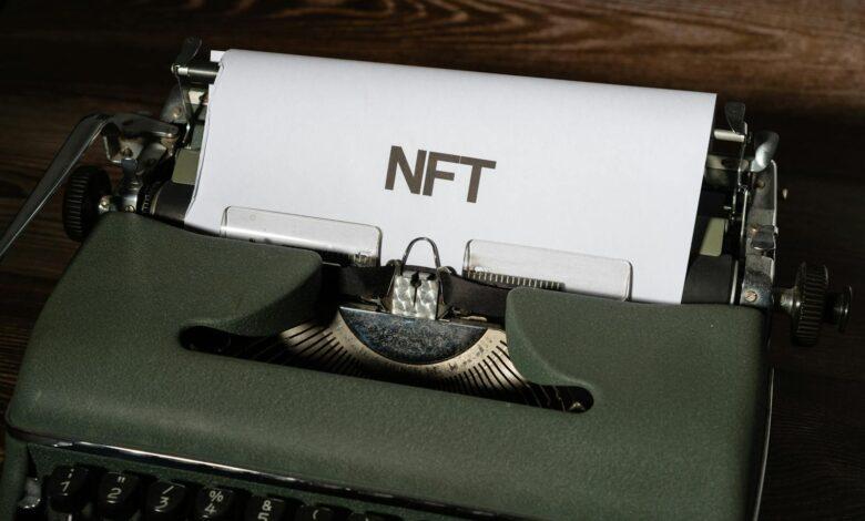 Close-up of a vintage typewriter with the word 'NFT' typed on paper, symbolizing digital innovation.