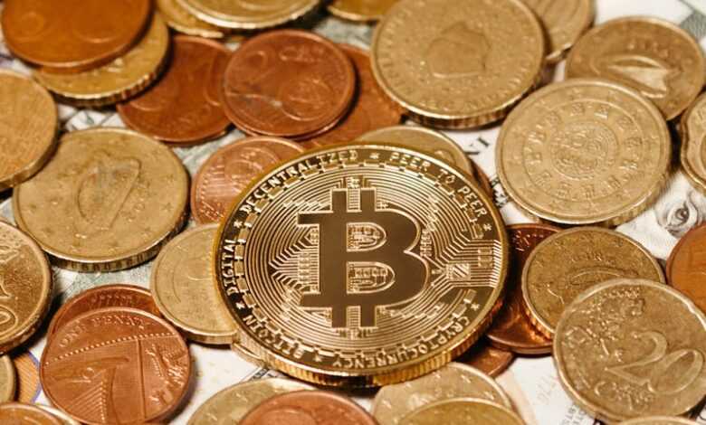 A golden Bitcoin placed among currency coins symbolizes digital and traditional finance.