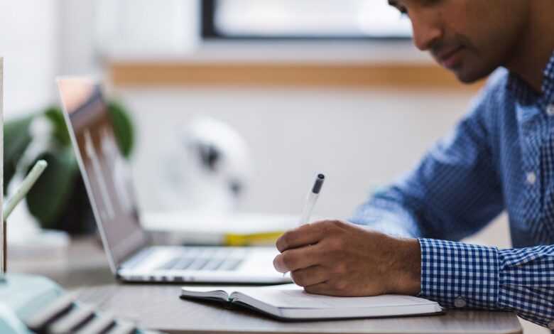 man, writing, laptop