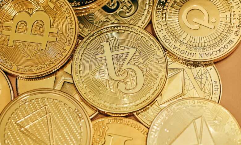 a pile of gold bitcoins sitting on top of each other