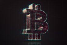 A shiny bitcoin logo on a black background