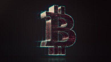 A shiny bitcoin logo on a black background