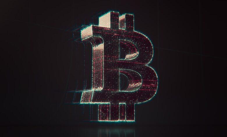 A shiny bitcoin logo on a black background