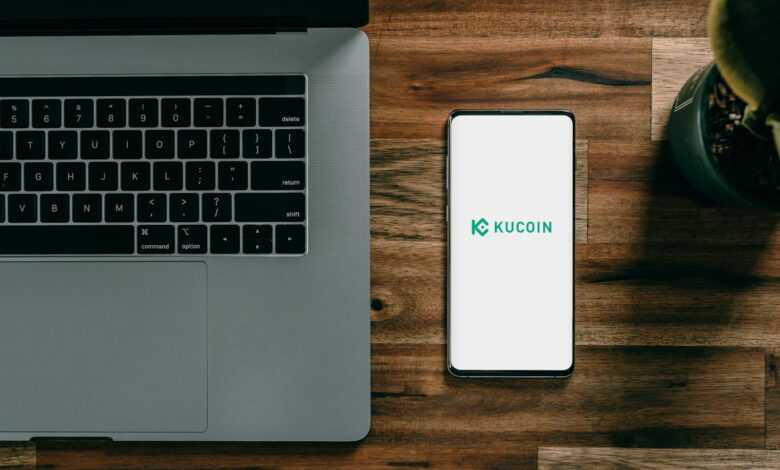a cell phone next to a laptop
