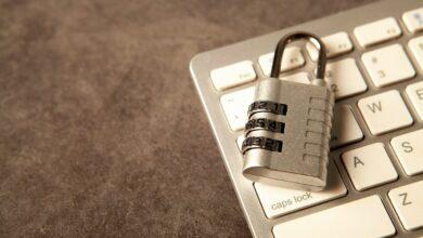 A padlock rests on a computer keyboard.