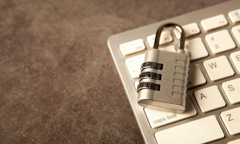 A padlock rests on a computer keyboard.