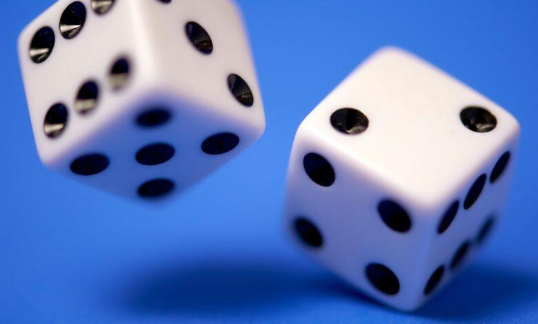 2 white dices on blue surface